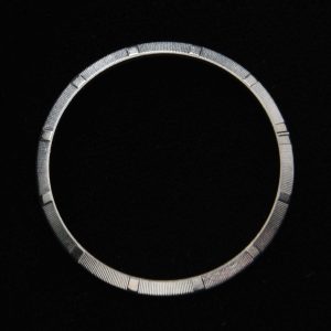 This stainless steel engine-turned bezel fits the ref. 1002-1003 34mm Rolex Oyster watch. This bezel looks pristine when viewed in person.