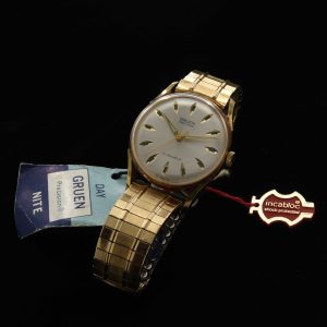 This is an uncommon and NOS (unused) vintage early '70s Gruen watch known as the Day/Night measuring 33mm in a pristine gold-plated case with hang-tags and sticker as it was sold new.