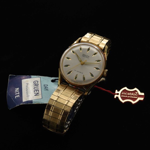 This is an uncommon and NOS (unused) vintage early '70s Gruen watch known as the Day/Night measuring 33mm in a pristine gold-plated case with hang-tags and sticker as it was sold new.