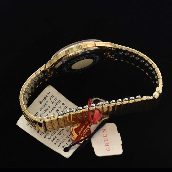 This is an uncommon and NOS (unused) vintage early '70s Gruen watch known as the Day/Night measuring 33mm in a pristine gold-plated case with hang-tags and sticker as it was sold new.