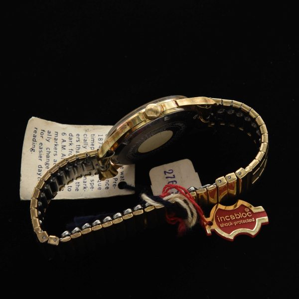 This is an uncommon and NOS (unused) vintage early '70s Gruen watch known as the Day/Night measuring 33mm in a pristine gold-plated case with hang-tags and sticker as it was sold new.