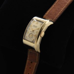 This is a very uncommon 1938 Gruen Extreme Driver’s watch known as the “edge-of-wrist watch” measuring 20x37mm with its 14k-gold-filled highly curved case.