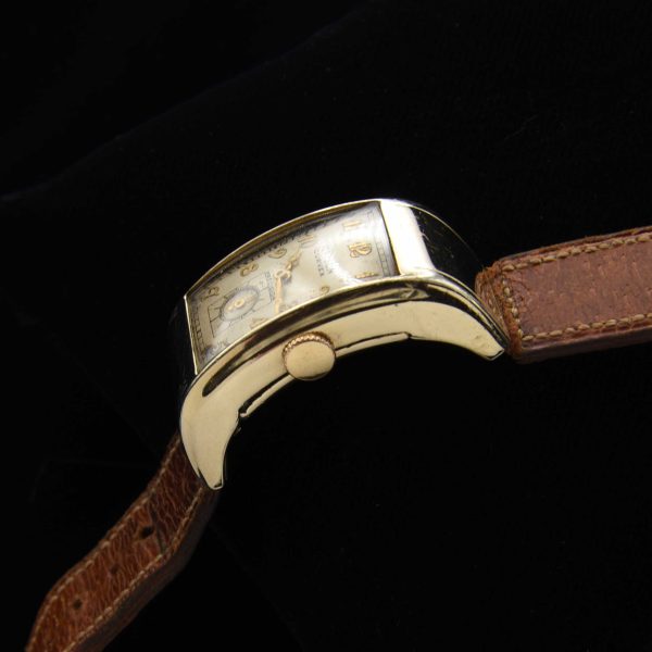 This is a very uncommon 1938 Gruen Extreme Driver’s watch known as the “edge-of-wrist watch” measuring 20x37mm with its 14k-gold-filled highly curved case.