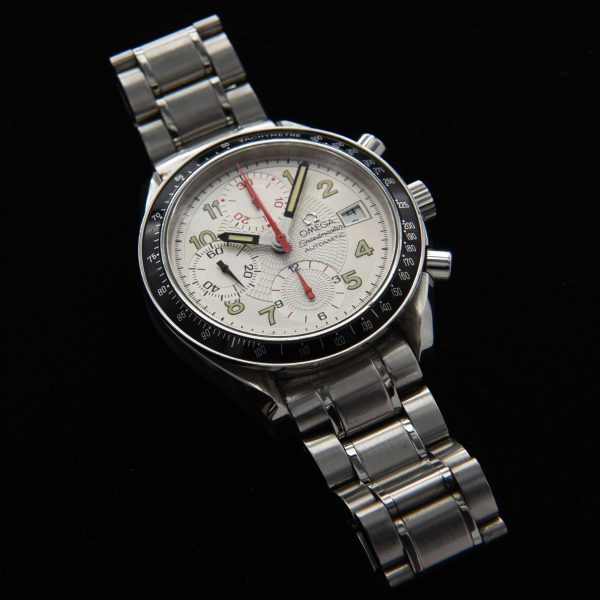 This 1996 Omega Speedmaster "Japanese Racing" has an uncommon polar-white dial with radiating-etched pattern with striking red and black accents.