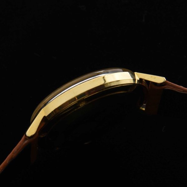 This is a spectacular and uncommon 18k-solid-gold 1960s vintage Movado Kingmatic with a heavy solid-gold-screw-back case.