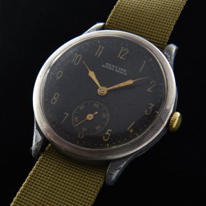 This WW2 era vintage Glycing watch measures a handsome 37mm with chrome sides and steel back. The wear on the case sides truly adds character to this military piece. The original black dial looks amazing with its gold-gilt print and stylized-Arabic numerals.