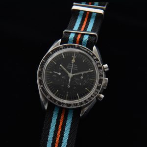 This is an honest and original example of a 1965 Omega Speedmaster ref. 105.012 chronograph measuring 42mm in steel. This watch retains the original dial, hands, hesalite crystal, case and rare dot-over-90 bezel.